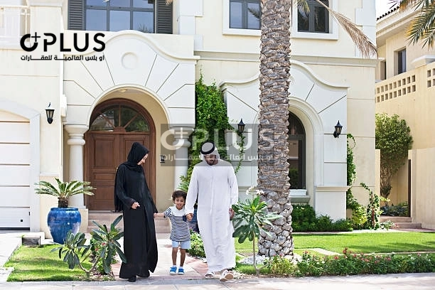Emirati family in front of new villa	