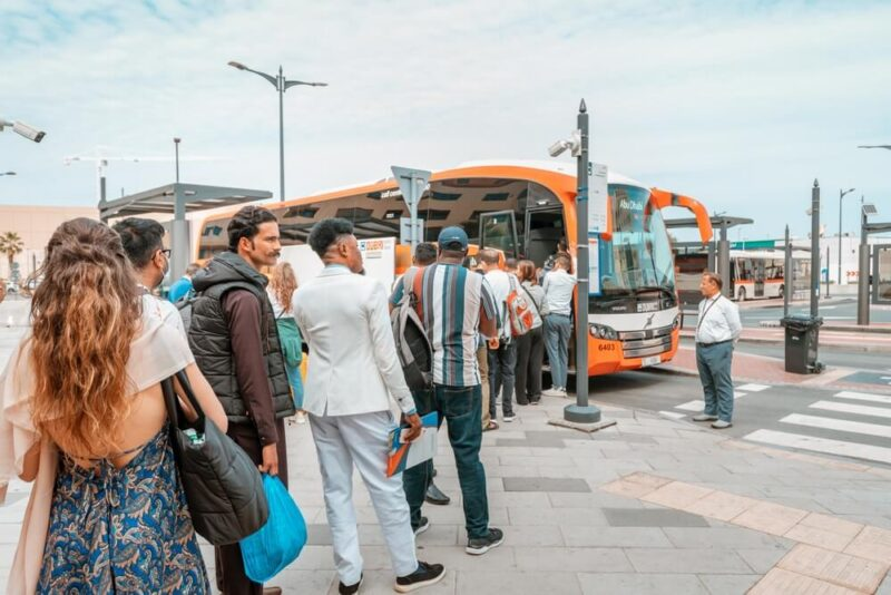 Ticket counter at a Dubai bus station with passengers buying tickets for Oman.